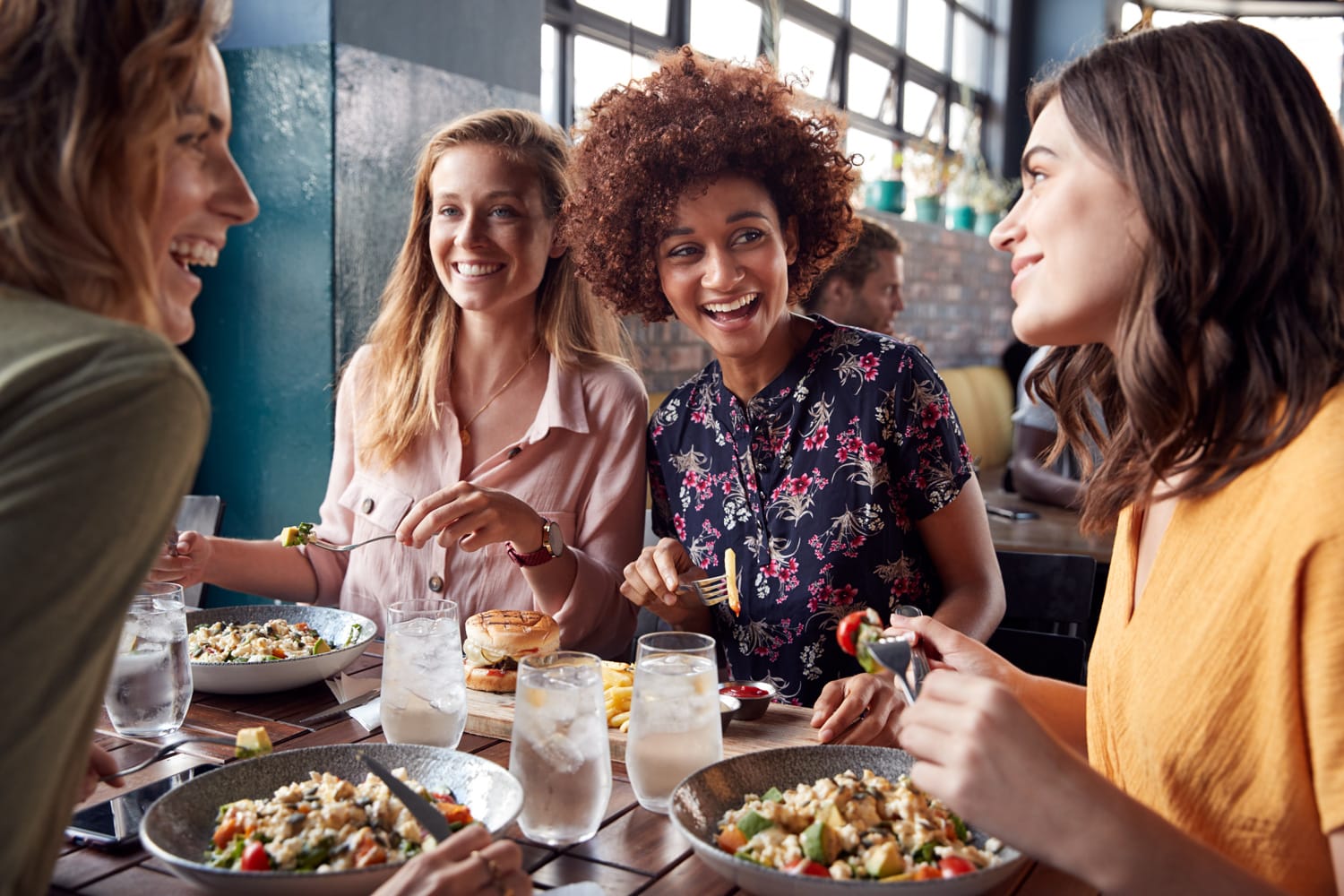 Women enjoying a healthy meal together in a bright, welcoming setting